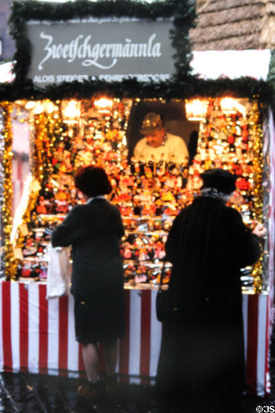 Booth of figurines made from prunes (Zwetschgenmännla) at Christmas Market on Frauen Kirche square. Nuremberg, Germany.