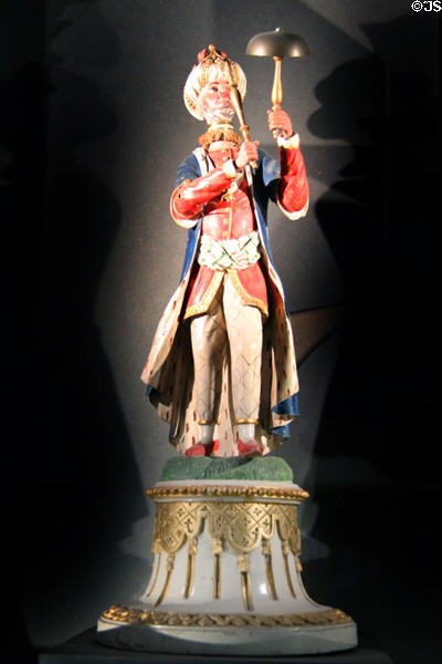 Wise Turk automaton tells which playing card a spectator has drawn at Teylers Museum. When the magician asks if it is a Heart, the man nods "no" or "yes". He rings the bell the same number of times as the value on the playing card. Haarlem, Netherlands.