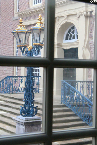 View of wrought iron railings & light fixture through multi-paned window. Het Loo, Netherlands.