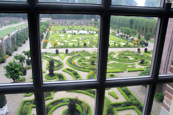 Formal gardens viewed through multi-paned window. Het Loo, Netherlands.