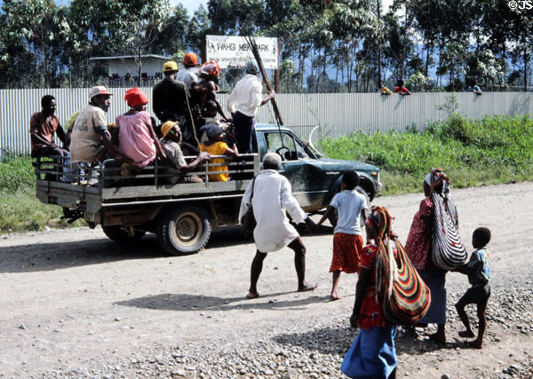 War party ride in pickup truck on road near Banz. Papua New Guinea.