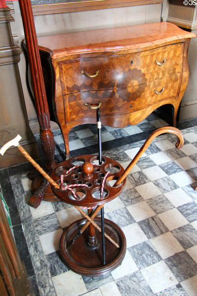 Cane rack & bow front bureau with marquetry in entrance hall at Lauriston Castle. Edinburgh, Scotland.