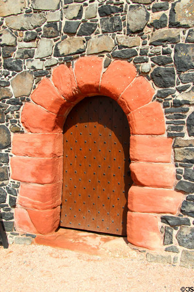 Red stone entrance arch at Smailholm Tower. Scotland.