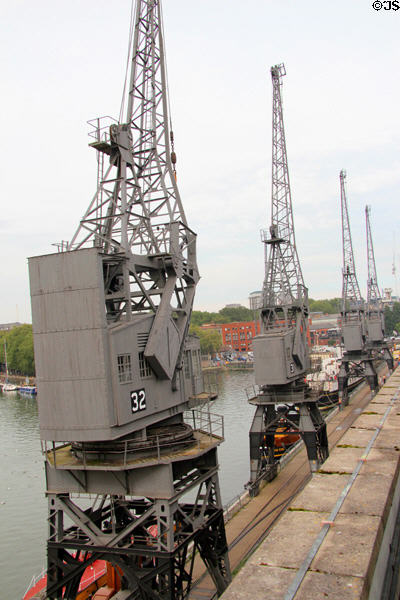 Row of antique cranes used when many ships laden with goods docked at Floating Harbour. Bristol, England.