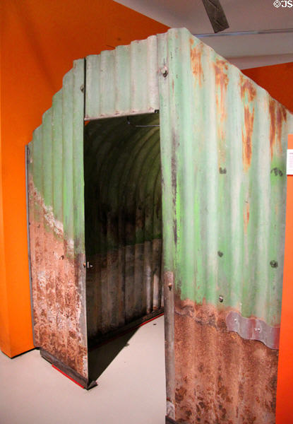 Anderson shelter, made of corrugated steel, used during WWII & distributed to home owners as "backyard" bomb shelters which were half-buried in ground & covered over with earth at M-Shed Museum. Bristol, England.