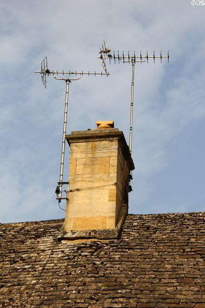TV Aerials atop typical Cotswold slate roof. Stanton, England.