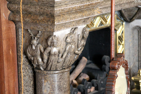 Mythical carved stone figures next to library fireplace in Penrhyn Castle. Bangor, Wales.