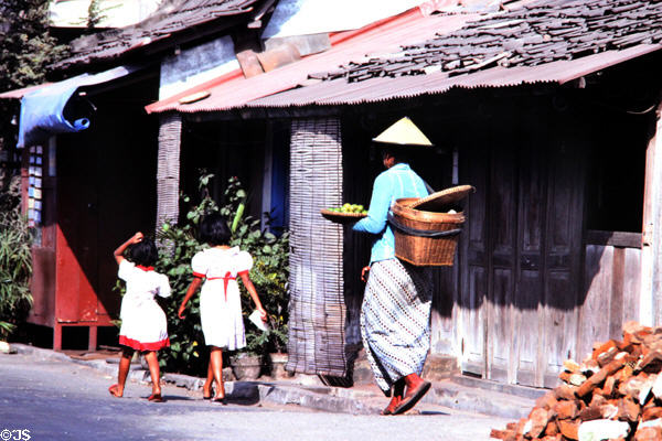Woman with daughters in street. Jogyakarta, Indonesia.