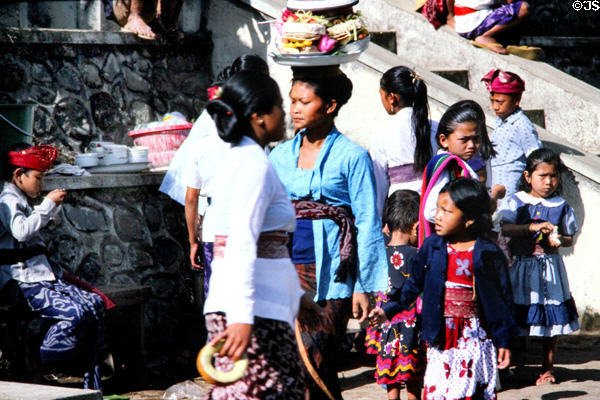 Women with children at temple. Bali, Indonesia.