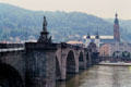 Statuary on Alte Brücke over Neckar River with tower of Heileggeiskirche (Church of the Holy Spirit in the background. Heidelberg, Germany.