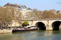 Stone arches of Pont Marie & buildings of Quai des Célestins,. Paris, France.
