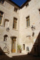 Courtyard of Palais du Roure hung with lamps & bells. Avignon, France.