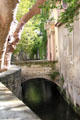 Historic neighborhood of rue des Teinturiers along river which once ran water wheels used by fabric workers. Avignon, France.