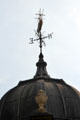 Weather vane with ship on vintage building. Bristol, England.