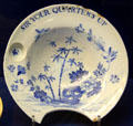 Ceramic barber's bowl with notice "Sir Your Quarters Up" to remind customers to pay their quarterly bill, made in Liverpool, at Bristol Museum & Art Gallery. Bristol, England.
