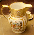 Gilded ceramic pitcher with unicorn crest plus French phrase "VIRTUTE ET INDUSTRIA" at Bristol Museum & Art Gallery. Bristol, England.
